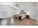 Spacious main bedroom with a high ceiling, ceiling fan, and two windows for abundant natural light at 1624 Savory Ln, Charlotte, NC 28216