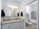 Bathroom featuring double sinks with granite countertops and modern fixtures next to a bathtub at 18511 Harborside Dr, Cornelius, NC 28031