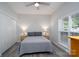 Bedroom featuring a comfortable bed with gray bedding, ceiling fan, closet, and bedside lamps at 18511 Harborside Dr, Cornelius, NC 28031