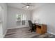 Neutral toned bedroom or office with a window, desk, and sleek, modern flooring at 18511 Harborside Dr, Cornelius, NC 28031