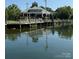Lakeside building with green roof and expansive windows reflected in the water, capturing picturesque scenery at 18511 Harborside Dr, Cornelius, NC 28031