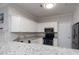 Modern kitchen with granite countertops, stainless steel appliances, and white cabinetry at 18511 Harborside Dr, Cornelius, NC 28031