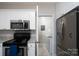Bright kitchen featuring stainless steel appliances, granite countertops, and convenient access to the laundry room at 18511 Harborside Dr, Cornelius, NC 28031