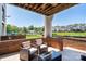 Relaxing patio with wicker chairs, coffee table, brick trim, and a view of the lush community landscape at 18511 Harborside Dr, Cornelius, NC 28031