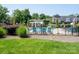 Community pool with lounge chairs and umbrellas, perfect for relaxation and enjoying the sunny weather at 18511 Harborside Dr, Cornelius, NC 28031