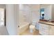 Bathroom with a tiled floor, a combined tub and shower unit, toilet, and vanity with granite countertops at 2143 Barrowcliffe Nw Dr, Concord, NC 28027