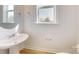 Bright bathroom featuring a pedestal sink, framed window, and white walls at 2143 Barrowcliffe Nw Dr, Concord, NC 28027