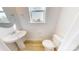 Powder room featuring a pedestal sink and toilet at 2143 Barrowcliffe Nw Dr, Concord, NC 28027