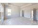 Bright bedroom with carpet flooring, large window and doorway leading to a closet at 2143 Barrowcliffe Nw Dr, Concord, NC 28027