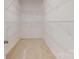 Walk-in closet features carpet flooring and white wire shelving for ample storage at 2143 Barrowcliffe Nw Dr, Concord, NC 28027