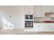 Modern kitchen featuring white cabinets, stainless steel appliances, granite countertops and backsplash at 2143 Barrowcliffe Nw Dr, Concord, NC 28027