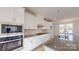 Modern kitchen with stainless appliances, granite countertops, and white cabinets at 2143 Barrowcliffe Nw Dr, Concord, NC 28027