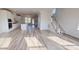 Bright, open-concept living room with hardwood floors, staircase, and an abundance of natural light at 2143 Barrowcliffe Nw Dr, Concord, NC 28027