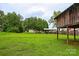 Expansive backyard featuring a playhouse, covered patio, and ample green space for recreation and relaxation at 218 Blacksnake Rd, Stanley, NC 28164