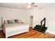 Bedroom with ceiling fan, built-in wardrobe, and steps leading to another room at 218 Blacksnake Rd, Stanley, NC 28164