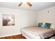 Bright bedroom features a ceiling fan and neutral colored walls and wood-look flooring at 218 Blacksnake Rd, Stanley, NC 28164