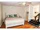 Inviting bedroom with wood-look flooring, neutral walls, and convenient access to the kitchen and outdoors at 218 Blacksnake Rd, Stanley, NC 28164