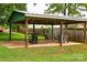 Backyard covered patio with outdoor seating and dining area perfect for enjoying meals and gatherings at 218 Blacksnake Rd, Stanley, NC 28164