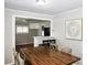 Dining room features a large wood table and partial view into the kitchen at 218 Blacksnake Rd, Stanley, NC 28164