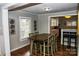Charming dining room with wood floors, a rustic table with seating for six, and open access to the kitchen at 218 Blacksnake Rd, Stanley, NC 28164