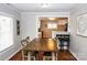 Open-concept dining room with hardwood floors flows into the modern kitchen, creating a seamless living space at 218 Blacksnake Rd, Stanley, NC 28164
