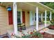 Cozy front porch featuring classic rocking chairs, red shutters, and blooming flowers creating curb appeal at 218 Blacksnake Rd, Stanley, NC 28164