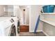 Bright laundry room with modern appliances, shelving, and gray tile flooring, providing a functional space at 218 Blacksnake Rd, Stanley, NC 28164