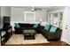 Comfortable living room featuring hardwood floors, a ceiling fan, and a cozy seating arrangement at 218 Blacksnake Rd, Stanley, NC 28164
