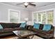 Cozy living room with hardwood floors, neutral walls, and comfortable brown sofas with bright accent pillows at 218 Blacksnake Rd, Stanley, NC 28164