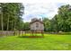 Elevated backyard playhouse with ladder, offering a fun and unique space for to enjoy at 218 Blacksnake Rd, Stanley, NC 28164