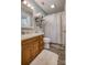 Bathroom featuring a single sink vanity, toilet, shower with curtain, and decorative shelves at 2526 Ashford Dr, Newton, NC 28658
