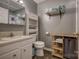 Bathroom featuring a vanity, toilet, shelving, and coordinated towels in a neutral color scheme at 2526 Ashford Dr, Newton, NC 28658