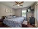 Serene bedroom with wood floors, a comfortable bed, ample natural light, and a ceiling fan for added comfort at 2526 Ashford Dr, Newton, NC 28658
