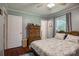 Comfortable bedroom with wooden floors, window, ceiling fan, and ample storage space at 2526 Ashford Dr, Newton, NC 28658