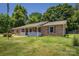 Charming brick home featuring a welcoming front porch and lush green lawn at 2526 Ashford Dr, Newton, NC 28658