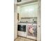 A laundry room with a modern washer and dryer, featuring unique decorative accents, and built-in storage at 2526 Ashford Dr, Newton, NC 28658
