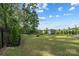 Green backyard featuring lush trees and manicured beds at 4046 Armstrong Farm Dr, Belmont, NC 28012