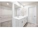 Bathroom featuring double sinks with white countertops, storage, and entry to a walk-in closet at 4046 Armstrong Farm Dr, Belmont, NC 28012