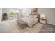 Primary bedroom with a bench seat, plush carpet, and modern decor, creating a cozy retreat at 4046 Armstrong Farm Dr, Belmont, NC 28012