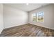 Bright and airy bedroom featuring hardwood floors and natural light through large windows at 4046 Armstrong Farm Dr, Belmont, NC 28012