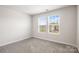 Bright bedroom featuring two windows and neutral carpet at 4046 Armstrong Farm Dr, Belmont, NC 28012