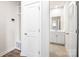 Hallway leading to a bathroom featuring tile floor, vanity, and mirror; closet on the left at 4046 Armstrong Farm Dr, Belmont, NC 28012