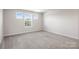 Empty living room featuring plush carpet, lots of natural light and neutral paint at 4046 Armstrong Farm Dr, Belmont, NC 28012