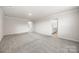Bright, open-concept living room with neutral tones, leading to a bathroom and secondary room at 4046 Armstrong Farm Dr, Belmont, NC 28012
