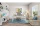 Bright home office with built-in bookshelves, a desk, and a comfortable armchair at 4046 Armstrong Farm Dr, Belmont, NC 28012