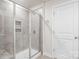 Modern tiled shower with glass door; a sleek and functional bathroom design at 4046 Armstrong Farm Dr, Belmont, NC 28012