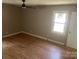 This bedroom features hardwood floors, a ceiling fan, and natural light from the window at 4050 Rollingwood Cir, Rock Hill, SC 29732