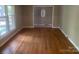 Spacious living room features gleaming hardwood floors and large windows offering natural light at 4050 Rollingwood Cir, Rock Hill, SC 29732