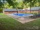 Backyard pool features a concrete deck and mature trees at 4050 Rollingwood Cir, Rock Hill, SC 29732