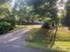 Long driveway leading up to a single-story home in the background with mature trees at 4050 Rollingwood Cir, Rock Hill, SC 29732